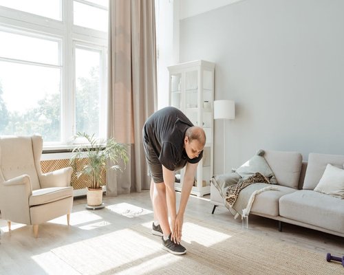 Person doing light stretching in a home office