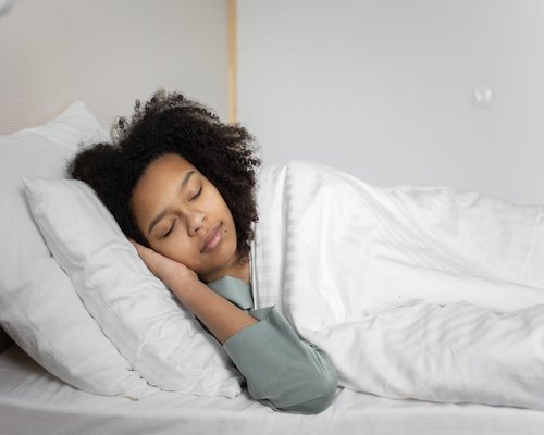 Person sleeping peacefully in a comfortable bed