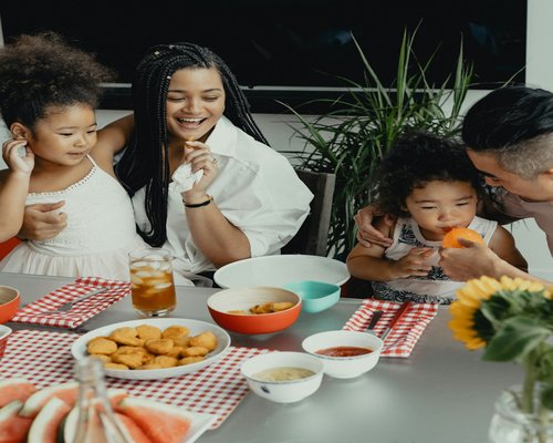 Family sitting around a table sharing a meal without phones